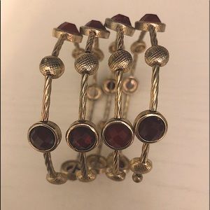 Gold cuff bracelet w/ruby colored stones
